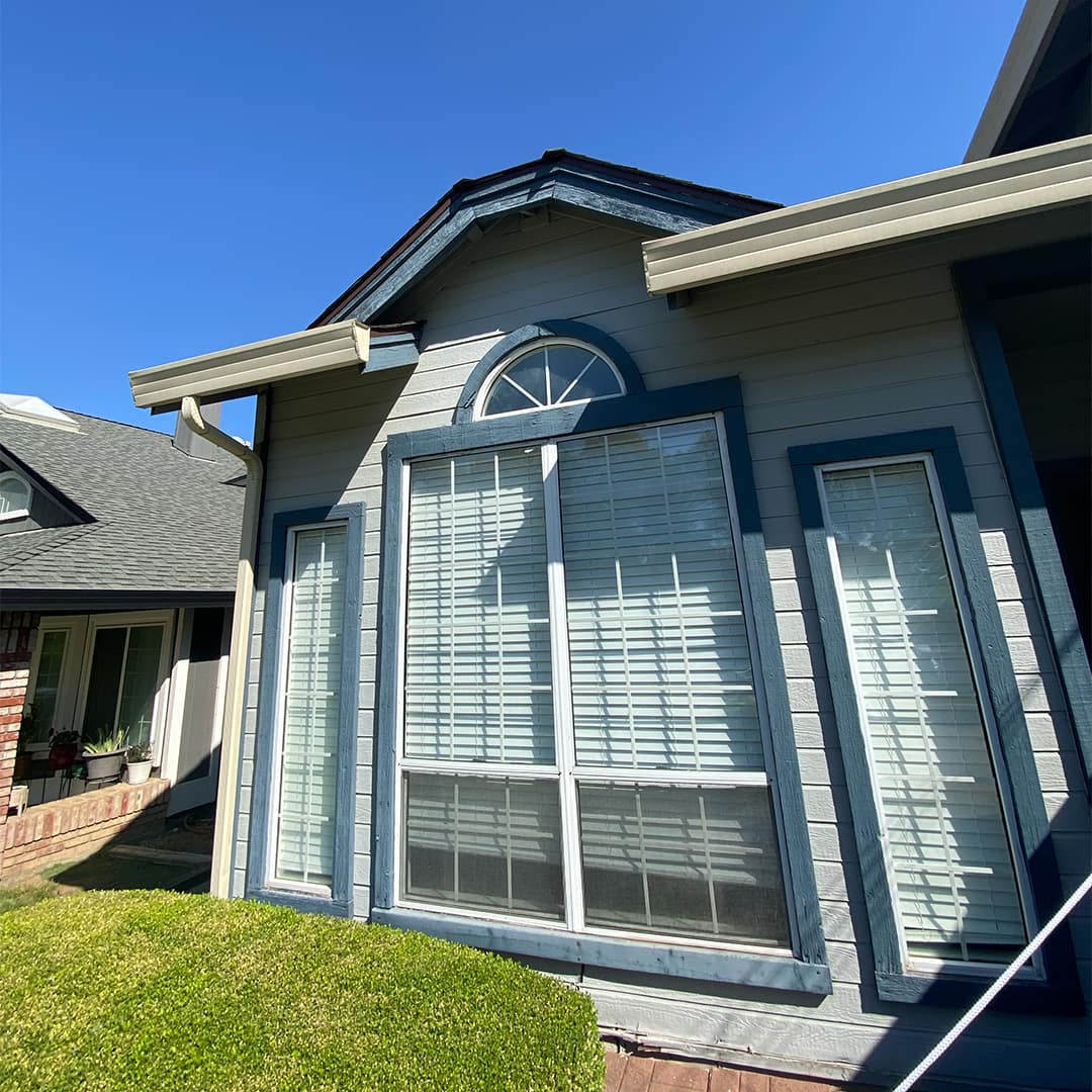 Residential home with custom arched and picture replacement windows installed by Best Exteriors, enhancing natural light and curb appeal.