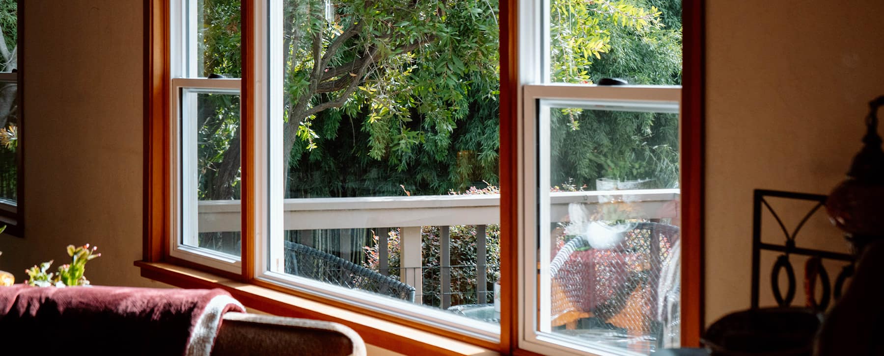 Interior view of newly installed energy-efficient replacement windows overlooking a backyard patio, completed by Best Exteriors.