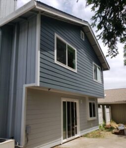 Completed blue and gray siding replacement on a two-story residential home in Oakland, CA.