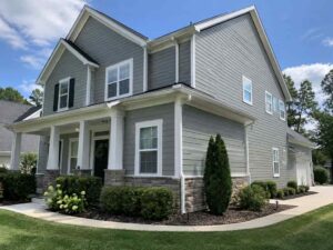 Completed gray siding replacement with white trim on a two-story home in Sacramento, CA.