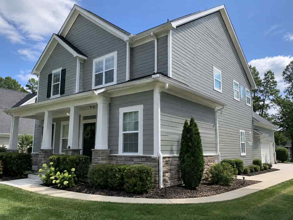 Completed gray siding replacement with white trim on a two-story home in Sacramento, CA.